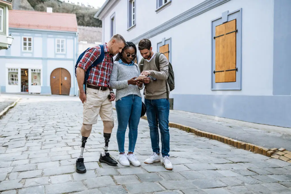 Amputee man traveling with friends and visiting city during springtime